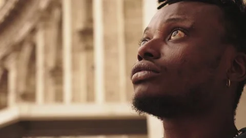 Prayer, hope, help concept. Young African boy praying looking at the sky Видео 218759644