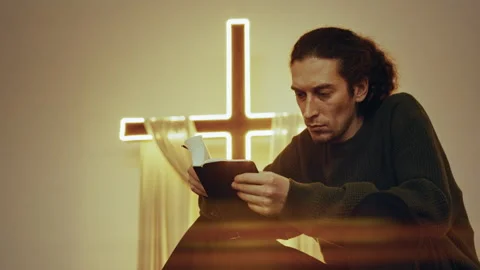 Prayer in a Modern Sanctuary: Bible Study Under Neon Glow cross Stock-Footage 327207860