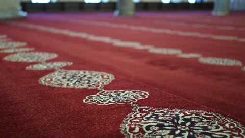 Prayer rug patterns in a mosque during quiet prayer time Stock Footage 332529212