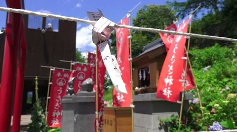Prayer Scroll Tied To Rope In Front Of Flags At Shinto Shrine 4K Vídeo Stock 46024807