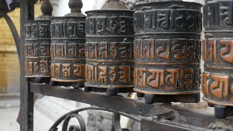 Prayer wheels one spinning comes to a stop Swayambhunath Temple Kathmandu Nepal Stock Footage 119381269