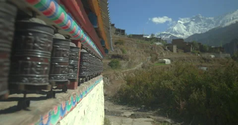 Prayer wheels with snowy mountains in background in Annapurna Circuit, Manang Stock Footage 341995539
