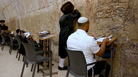 Prayers at the wailing wall in jerusalem by orthodox jews Stock Footage 337893247