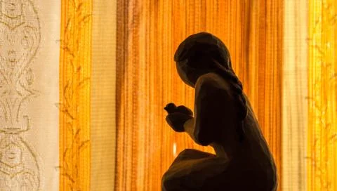 A praying angel on an orange background Stock Photos
