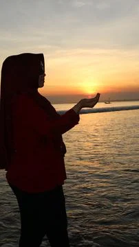 Praying at dusk on the beach Stock Photos