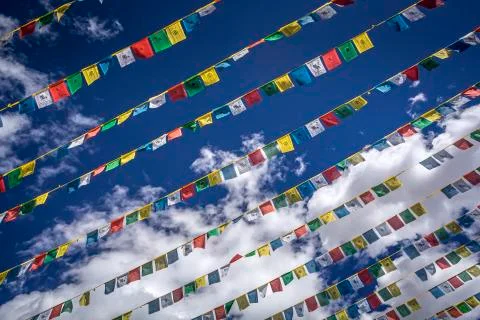 Praying flags in blue sky Stock Photos