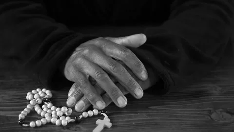 Praying to God with hand's together with cross and with people black background Stock Footage 333972611