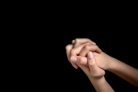 Praying hands is in the dark Stock Photos