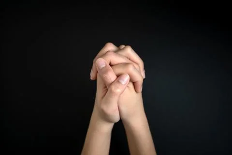 Praying hands is in the dark Stock Photos