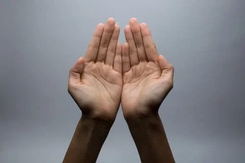 Praying Hands on a grey background Stock Photos
