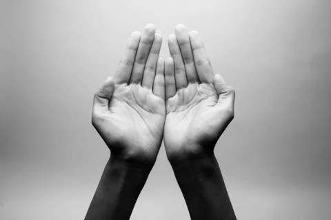 Praying Hands with a grey background Stock Photos