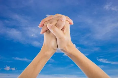 Praying Hands Isolated on sky background. Stock Photos