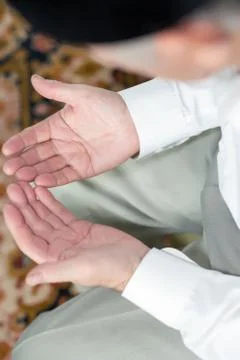 Praying hands of an old man Stock Photos