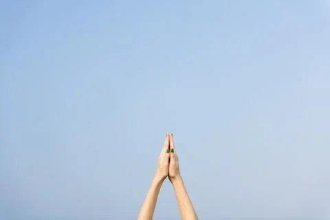 Praying hands pointed towards the sky, yoga excercise and stretching concept Stock-Fotos