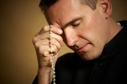 Praying priest Stock Photos