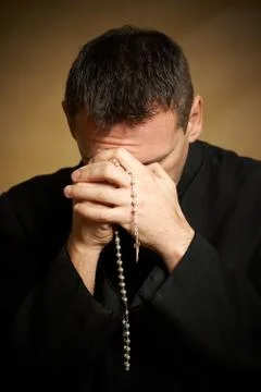 Praying priest Stock Photos