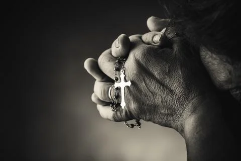 Praying with a rosary Stock Photos