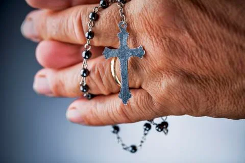 Praying with a rosary Stock Photos
