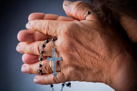 Praying with a rosary Stock Photos