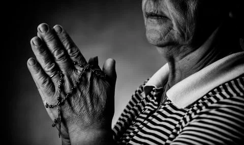 Praying with a rosary Stock Photos