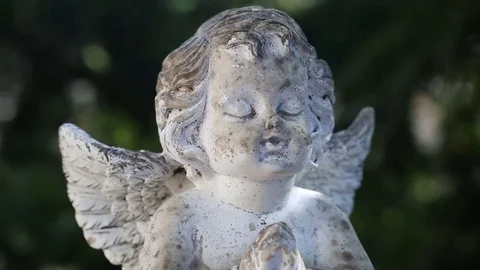 Praying stone angel on rotating plate Stock Footage 74025544