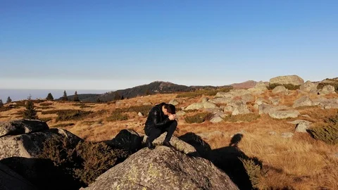 Praying On a Sunset Rock Stock Footage 100333595