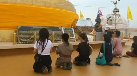 Praying women in front of stupa Stock Footage