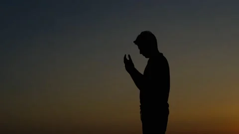 Praying young man silhouette Video stock 159867510