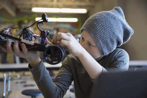 Pre-adolescent boy programming robotics at laptop in classroom 스톡 사진