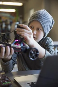 Pre-adolescent boy programming robotics at laptop in classroom 스톡 사진