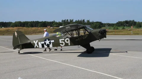 Pre-flight inspection of Piper L-4 at air show Stock Footage 27533058