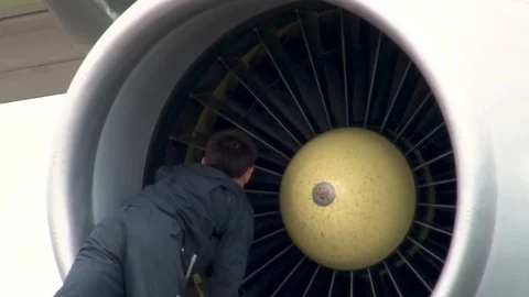 Pre-flight preparation on Il-78 tanker. Technician rotates engine. Stock Footage 108428615