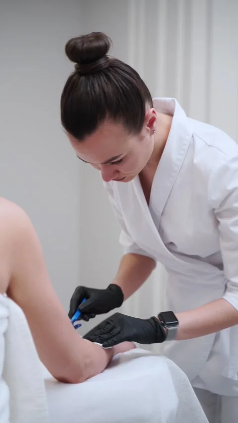 Pre-laser hair removal preparation with professional aesthetician meticulously Stock Footage 257714853