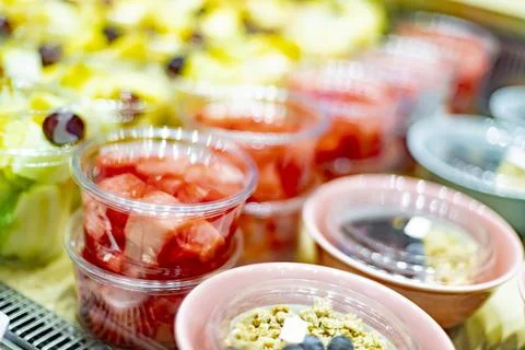 Pre-packaged fruit salads displayed in a commercial refrigerator Foto stock