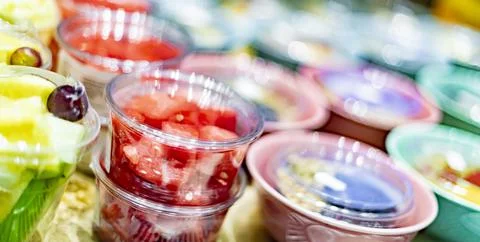 Pre-packaged fruit salads displayed in a commercial refrigerator Stock Photos