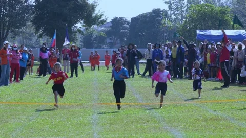 Pre-primary school children run in a race in Chiang Rai, Thailand on Decemb.. Stock Footage 259691000