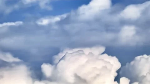 Pre-rain Dramatic fluffy clouds half backlit by sun move against blue sky Stock Footage 234718416