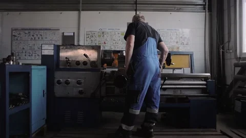 Pre-retirement locksmith adjusts a large machine tool Stock Footage 212401947