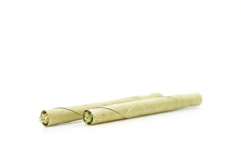 Pre rolled marijuana blunt cigars filled with weed isolated on white background Stock Photos