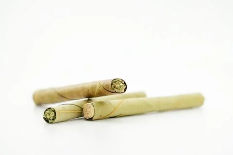 Pre rolled marijuana blunt cigars filled with weed isolated on white background Stock Photos