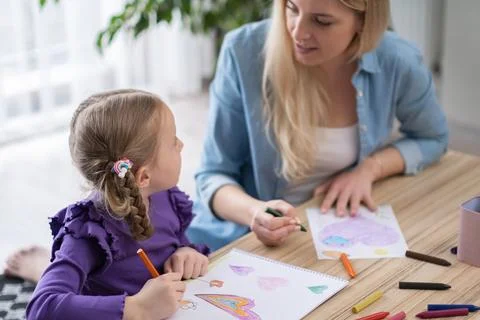 Pre school art class for creativity. teacher helps to little girl to learn Stock Photos