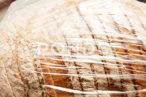 Pre sliced bread with flour in a simple see through transparent plastic ...