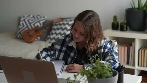 Pre teen girl doing homework, studying online from home watching web class or Stock Footage 166325210