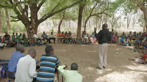 Preacher speaking to congregation under tree 動画素材 59796722