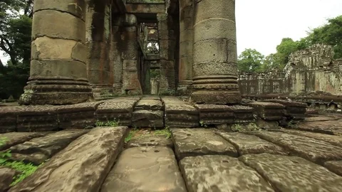 Preah Khan ancient temple smooth tracking first person shot along raised walkway Stock Footage 76381916