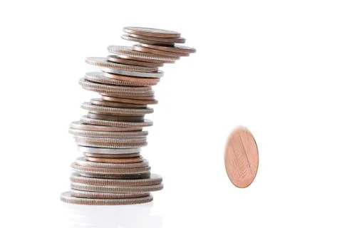 Precarious stack of coins falling Stock Photos