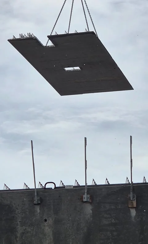 Precast concrete floor panel hoisted in rain vertical 9:16 Stock Footage 342049777