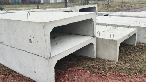 Precast concrete storm drain sections stacked outdoors on construction site Stock Footage 341657599