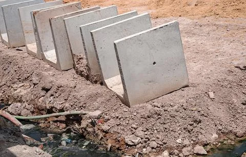 Precast Concrete U Drains Lined Up at Construction Site Foto stock