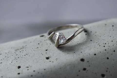 A precious diamond ring on gray concrete.macro Stock Photos